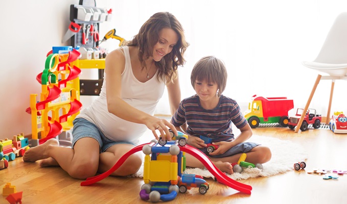 Picture of a mom and a boy playing toys showcasing the application of toy