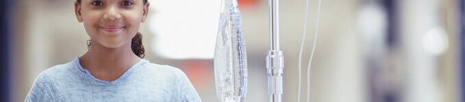 Young girl in hospital with IV bag